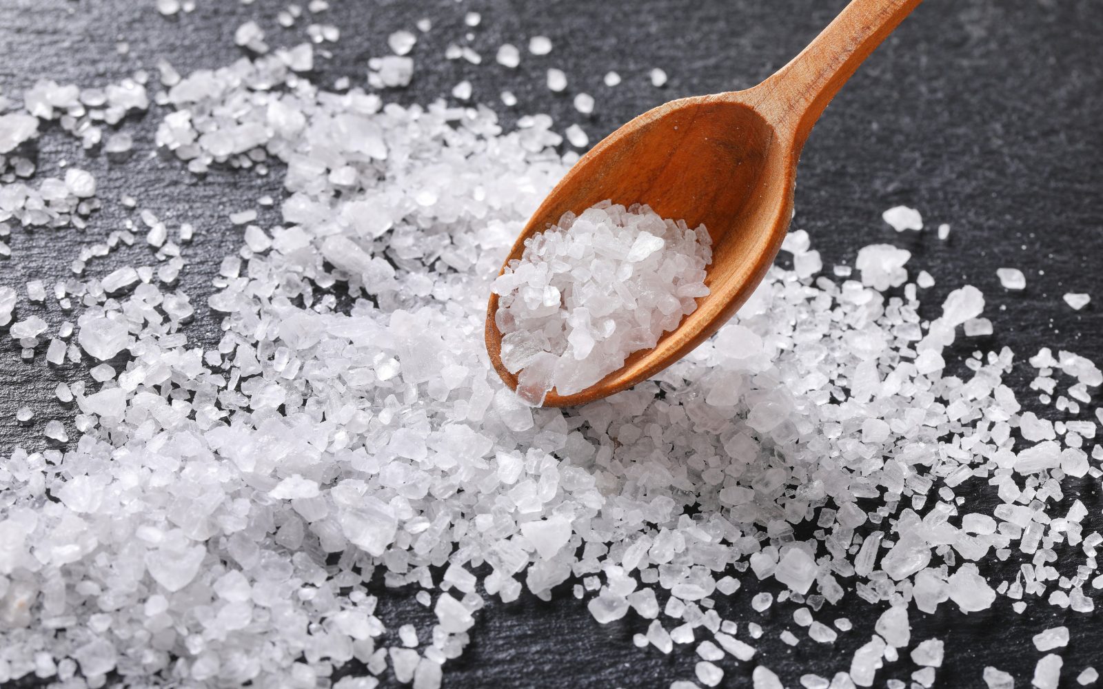 grobo mleta sol na mizi in leseni žlici