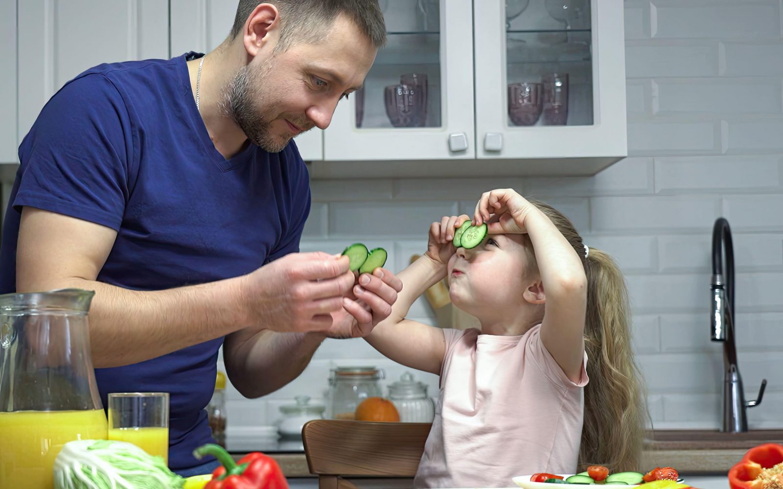 Oče in hči kuhata zdravo kosilo in se pri tem zabavata