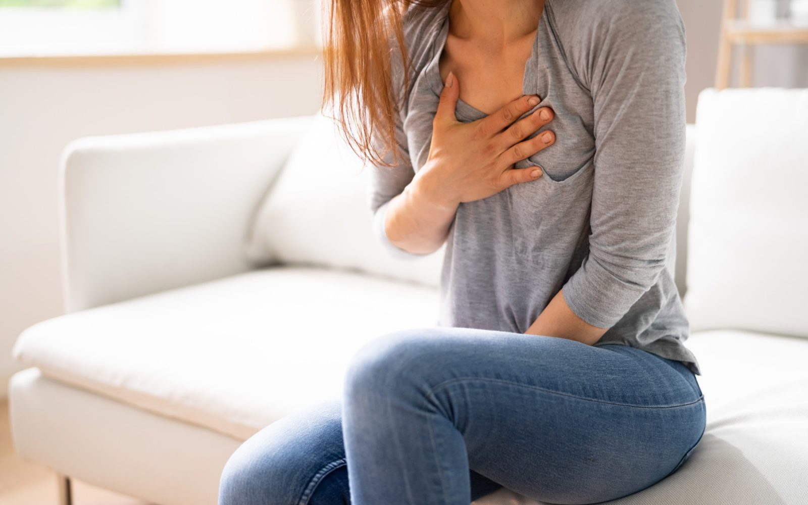 Žensko stiska v prsih, lahko gre za srčni infarkt ali tesnobo.