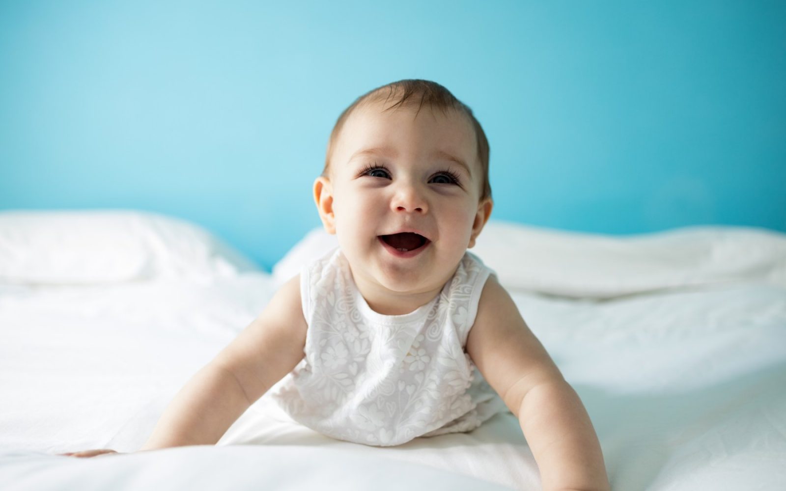 Nasmejan dojenček, ki se odziva z nasmehom – prvi primer čustvene nalezljivosti v otroštvu.