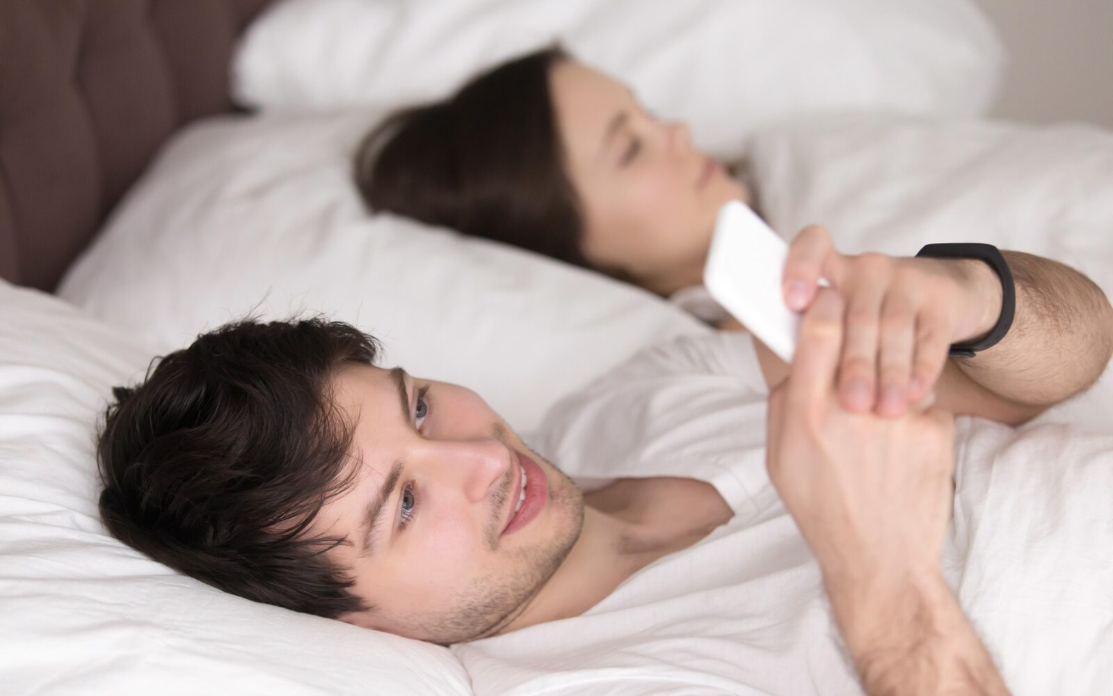 Čeden mož v postelji s posebno ženo je buden in če pošilja sporočila po pametnem telefonu, klepeta z ljubico, skriva skrivno afero ali pa preprosto ne more spati. Koncept varanja in nespečnosti.